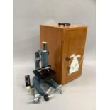 Microscope in case with various lenses, slides and accessories