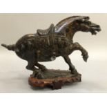 Tang dynasty style carved composite marble horse rearing with saddle on fruitwood base 17cm high
