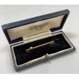 A George V diamond tie pin in 9ct. gold, the old European cut stone collet set, off centre of the