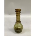 A green long necked oil bottle with applied moulding, 18cm high