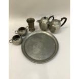 Planished pewter charger, 35cm diameter, two pewter coffee pots, milk jug sugar bowl and sectioned