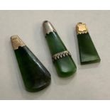 Three late 19th/ early 20th century Nephrite Jade pendant all of Toki form, variously set in 9ct