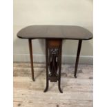 An Edwardian mahogany Sutherland drop leaf table with carved fret work to the side