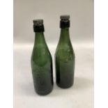 Green glass bottle with screw top, impressed with, 'Colchester Brewing Limited' with eagle crest,