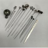 A collection of twelve late 19th and early 20th Century hat pins and a pair of silver sword hilted