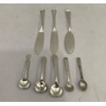 A pair of Edward VII silver butter knives each with a horse shoe scroll terminal Sheffield 1907, D &