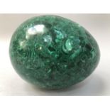 A malachite specimen carved as an egg, 20cm long