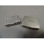 A silver pill box, rectangular, the hinged cover of engine turned decoration with vacant