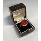 An 18th Century Carnelian ring the oval cabochon stone within a closed back collet setting with