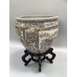 Large Chinese famille rose fish bowl the exterior painted with reserves of imperial scenes