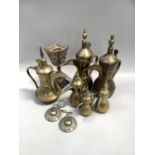 Quantity of six Arabic brass Dallah coffee pots of varying sizes, Tingsha cymbals and brass candle