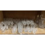 A large quantity of glassware comprising 6 wine hock glasses, three decanters, 8 champagne flutes,