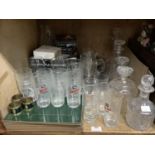 A pair of cut glass decanters with ring neck and mushroom stoppers, three further decanters,