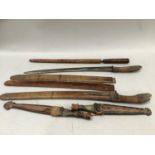 Quantity of eastern daggers, two with carved handles etc