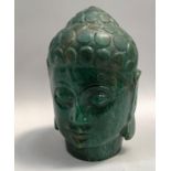 Carved green specimen stone head of Buddha, 22cm high
