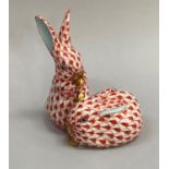 Herend figure group of two rabbits one upright, in red fishnet pattern with gilt detailing,
