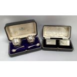 A boxed pair of Art Deco silver napkin rings of rectangular outline with cut corners each initialled