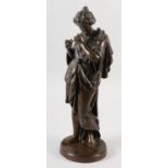 A 19th century bronze figure of a classical femal, standing, playing a flute, on circular plinth,