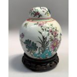 Chinese famille rose ginger jar and cover, overpainted with insects in foliage on carved hardwood