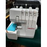 Necchi electric overlock sewing machine with colour coded threading guide with lead and cloth bag.