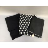 A length of black wool dressmaking fabric, a length of black crepe dressmaking fabric and a length