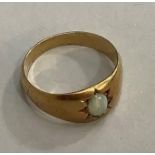 A Victorian Opal ring in 15ct gold, the oval cabochon stone star set within broad shoulders.