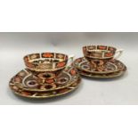 Pair of Royal Crown Derby imari pattern cups and saucers with two tea plates