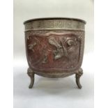A Japanese bronze jardiniere cast with two reserves containing birds and scholars in heavy relief