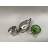 A Liberty & Co. silver salt cellar and pepper pot, both Pattern 50387, finished with indented