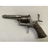 A replica pin fire revolver, stamped ACIER FONDUE, foliate chasing to the cylinder and frame