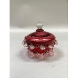 A Victorin cranberry dish and cover, moulded with shell edging and feet, 13cm high