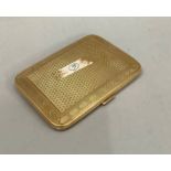 A cigarette case in 9ct. gold, barleycorn within a Greek key pattern. Engine turned, of