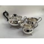 Mappin and Webb silver plated three piece tea service comprising teapot with ebonised handle and