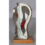 A stoneware sculpture, incised and glazed in green-white, red and white, on a wooden base, c1970s