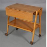 A Remploy oak veneered drop leaf trolley with undertier, on 'A' frame standards and castors, 73cm