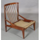 A teak chair, c1970s, railed back, pierced side frame on tapered legs (without cushions)