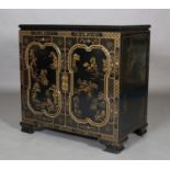 A Chinese black lacquered and gilt television cabinet having two moulded doors, with island and