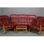 Ekornes, Norway, A Montana teak framed and maroon nappa leather three seater sofa together with a