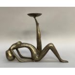 White metal candle holder modelled as an abstract reclining nude 34cm high