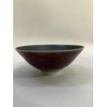 Peter Sparrey British (b1967) A Studio porcelain bowl, copper red, glaze, back oxidised internal