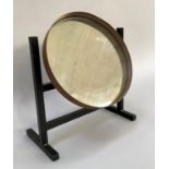 A mid 20th century, swing mirror, black metal double bar and cradle supporting round mirror set into