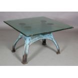 A cast iron and glass 'industrial-style' centre table, having a thick opaque riven glass surface