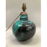 A Studio pottery table lamp of turquoise and black streaked craquel glaze, compressed circular