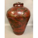 Chinese lacquered lidded vase of baluster form, decorated in relief with dragons chasing the flaming