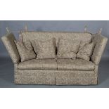 A Knowle sofa upholstered in pale brown and fawn scroll pattern fabric, with matching scatter