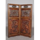 A pair of Chinese hardwood hanging panels, rectangular, pierced fruiting vine above a panel carved