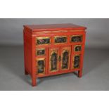 A 19th century Chinese red lacquered cabinet, moulded and panelled, having an arrangement of five