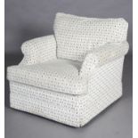 An armchair upholstered in neutral tones. PLEASE NOTE The items of furniture offered in this sale