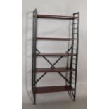 A Ladderax teak and black metal bookshelf having two ladder uprights, 131cm high x 20cm deep, five