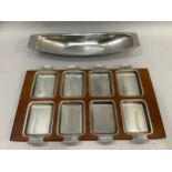 Kockum, Sweden, A teak and stainless steel hors' d'oeuvre tray fitted with eight dishes, 53.5cm x